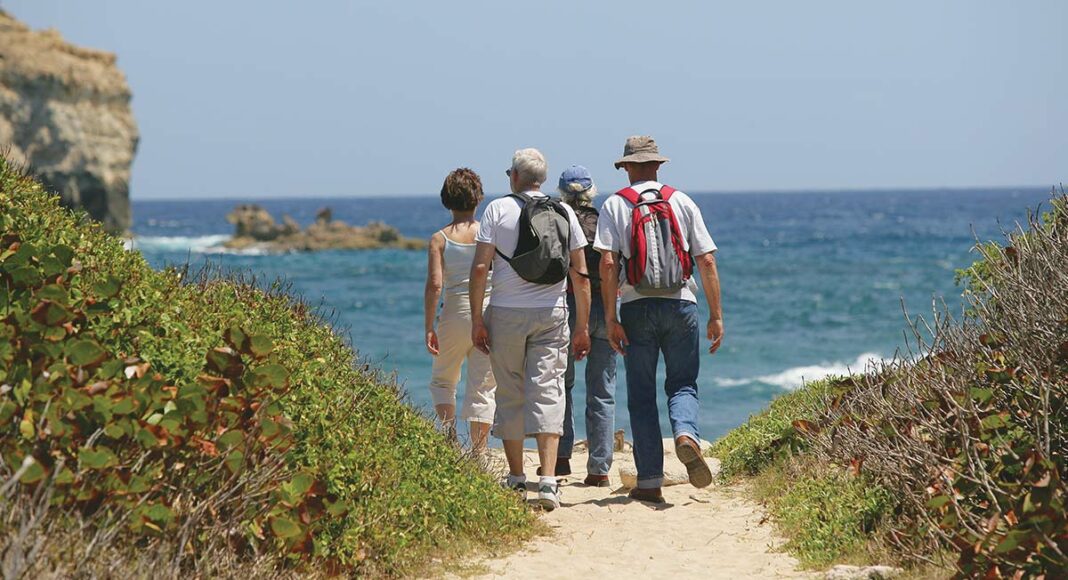 adults hiking on the beach