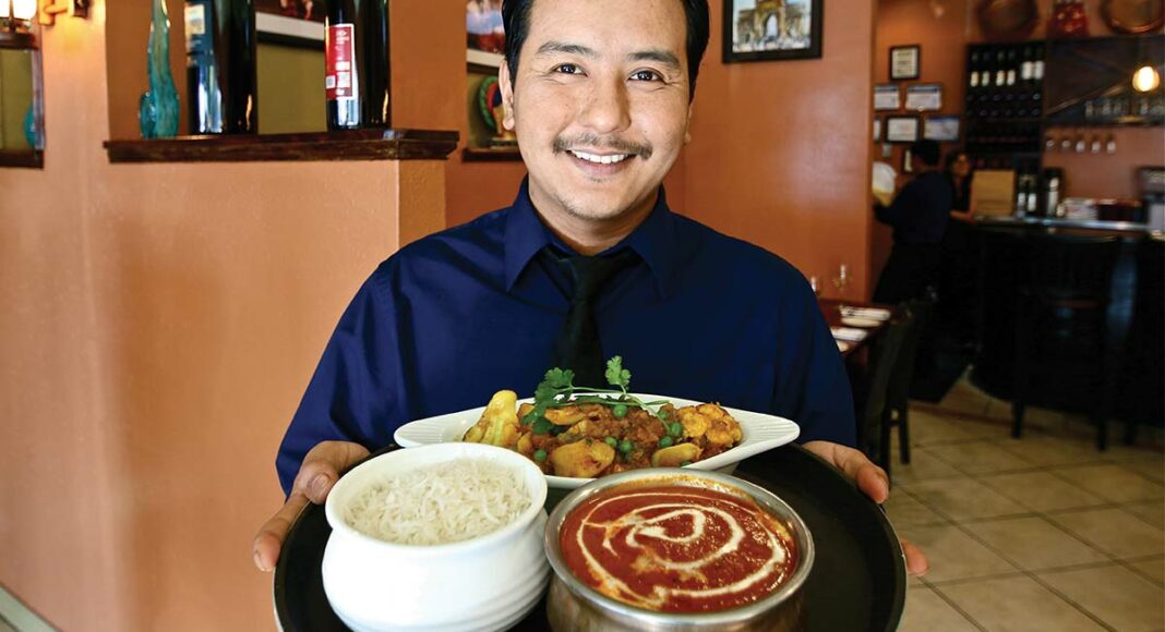 Subash Subba Chongbang, manager of Mumbai Delights, with butter chicken, aloo gobi and white basmati rice.