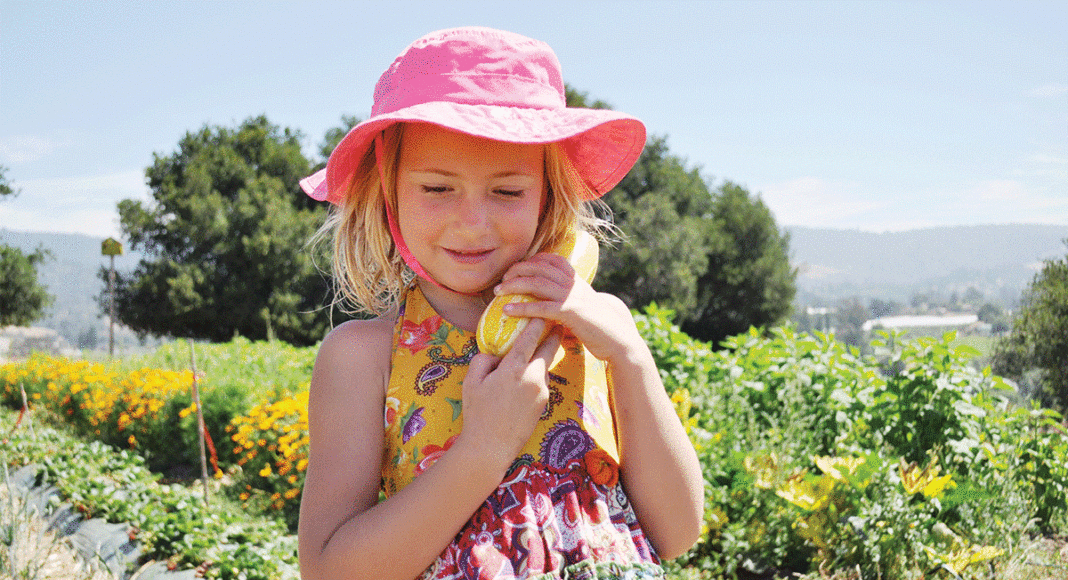 girl with squash at Live Earth Farm