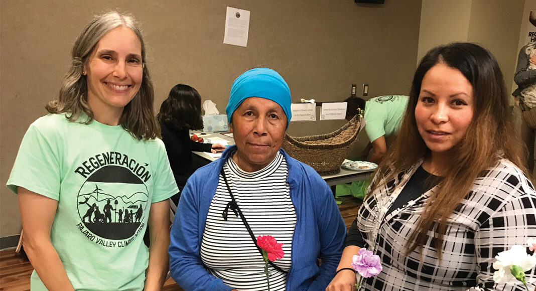 climate change impacts, Nancy Faulstich, coordinator of the ‘Regeneración: Climate of Hope’ study, stands with two local farm workers at an unveiling of the climate change data in Watsonville.