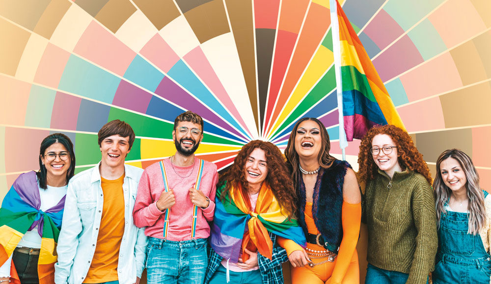 Group of happy people before a colorful geometric background.