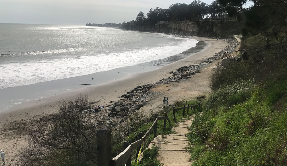 View of staircase down to a beach