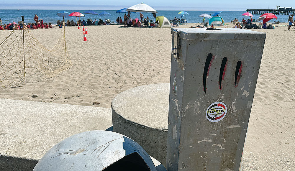 Tall metal receptacle near the beach