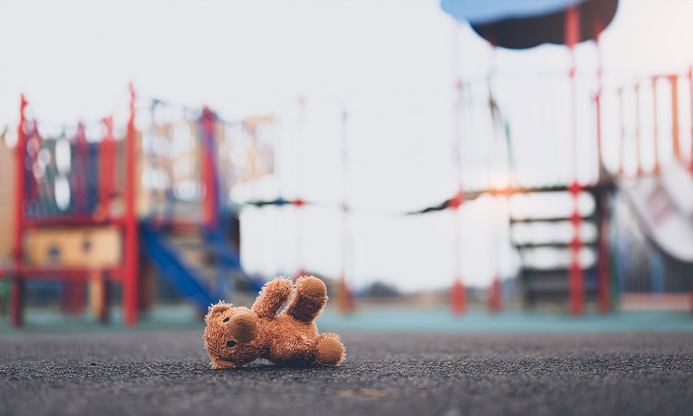 teddy bear abandoned on a street