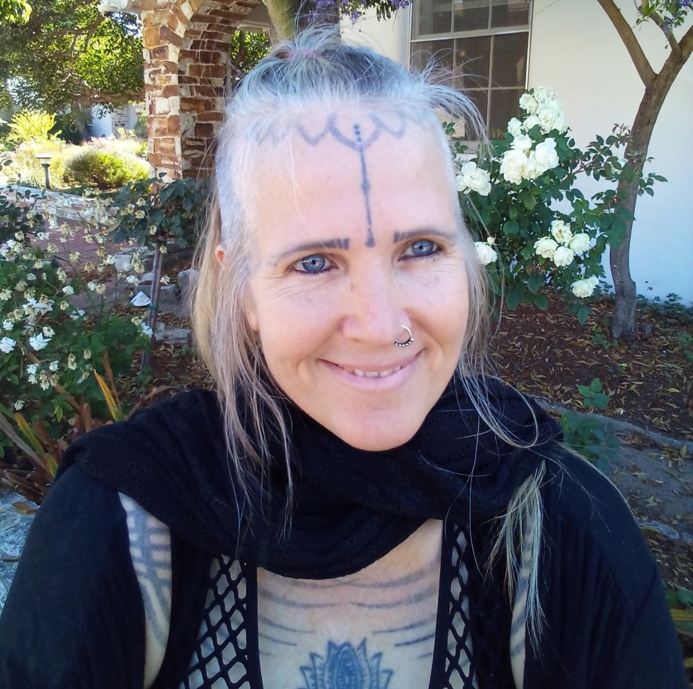 51 year old Jozee Roberto with mystical tattoos and black clothes