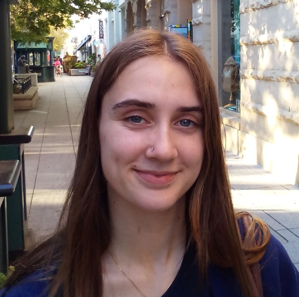 21 year old Allie Brandt with long brown hair in dark shirt