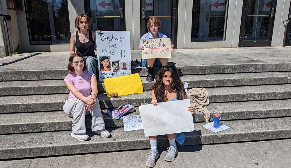 Young people sitting on the steps of a building