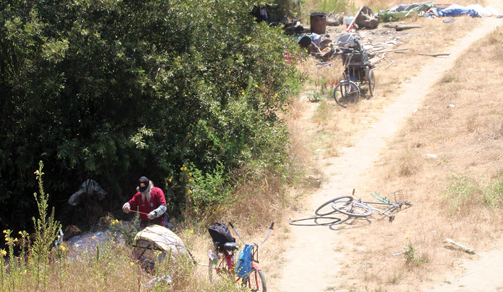 Man clearing possessions from his outdoor campsite