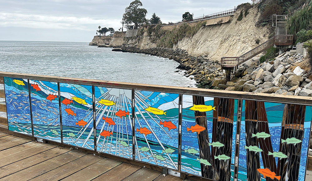 Photo taken from Capitola Wharf showing new artwork on the wharf and the cliffs along the shore