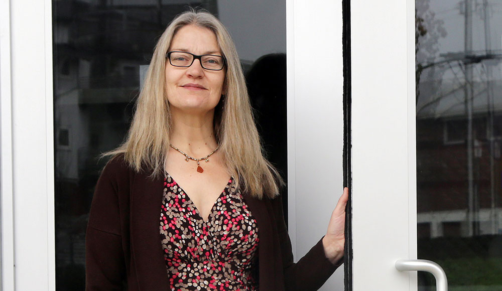 Woman standing in front of glass doors